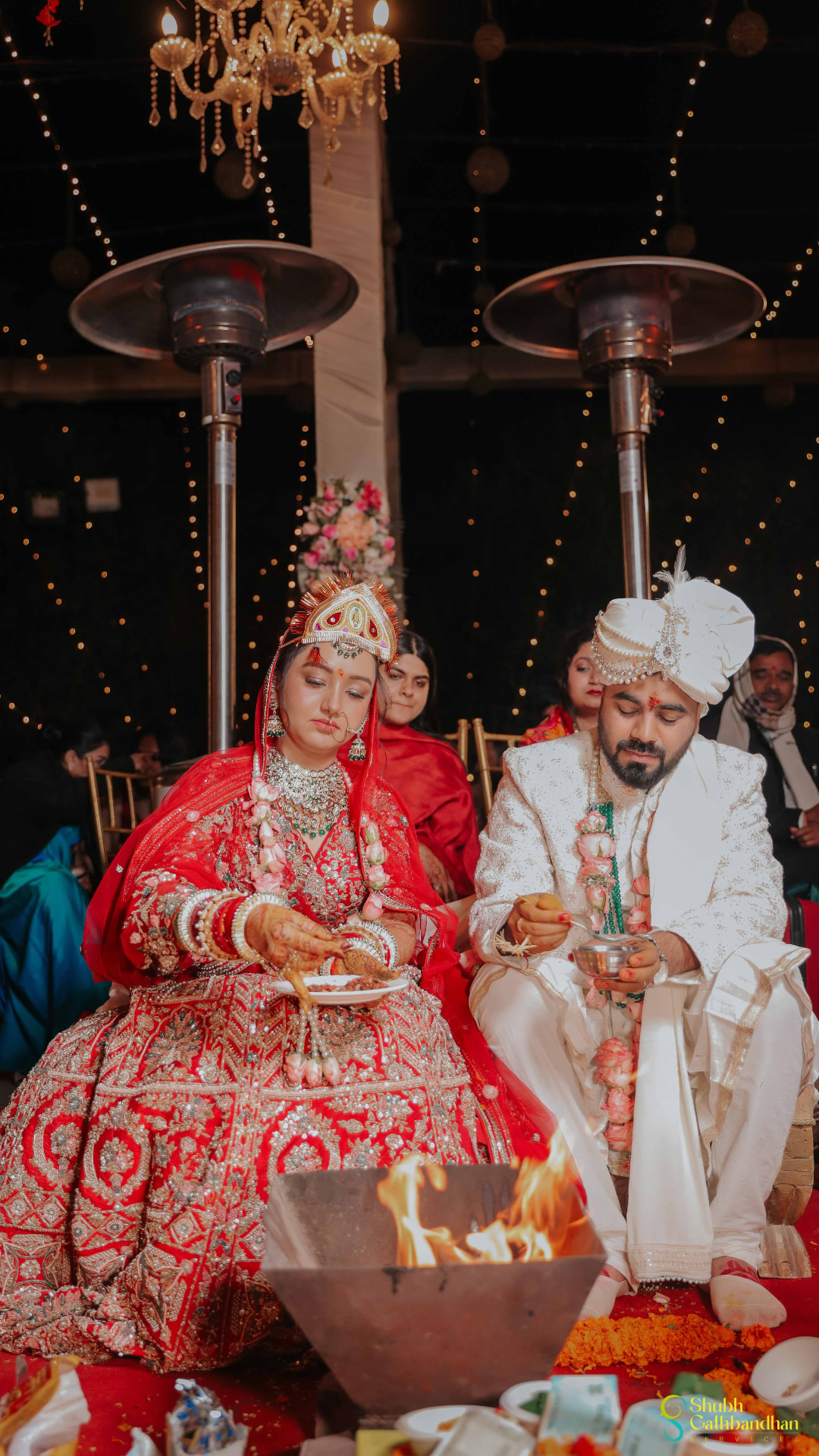 Anand and Soumya seated at the havan, offering ghee into the sacred fire