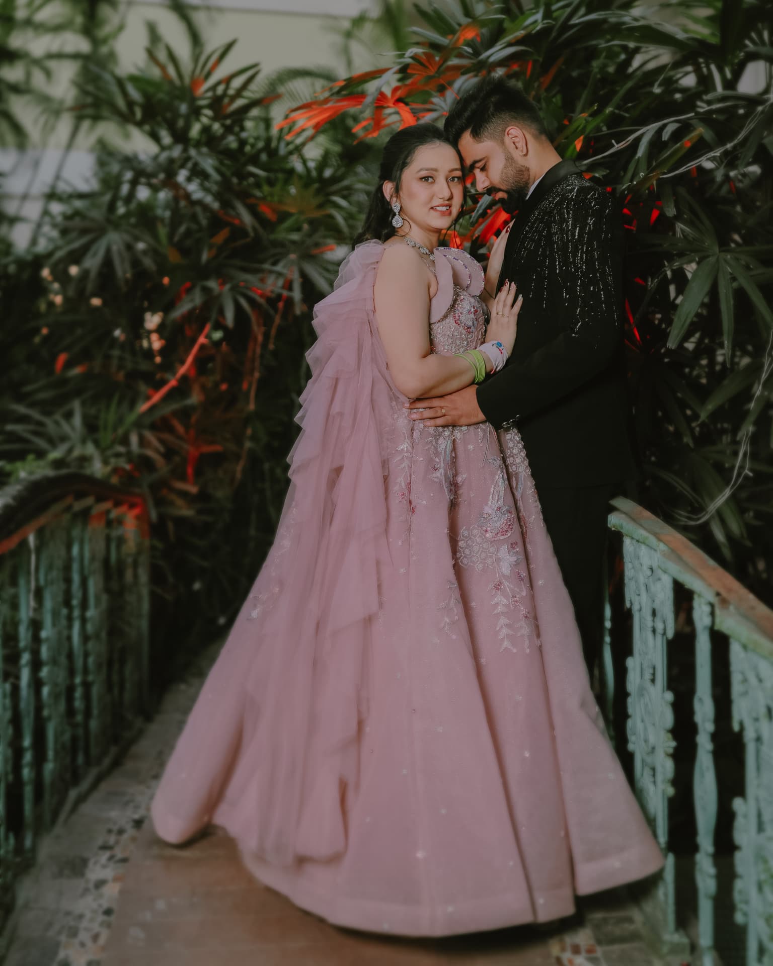Soumya in a blush gown with Anand on the garden bridge