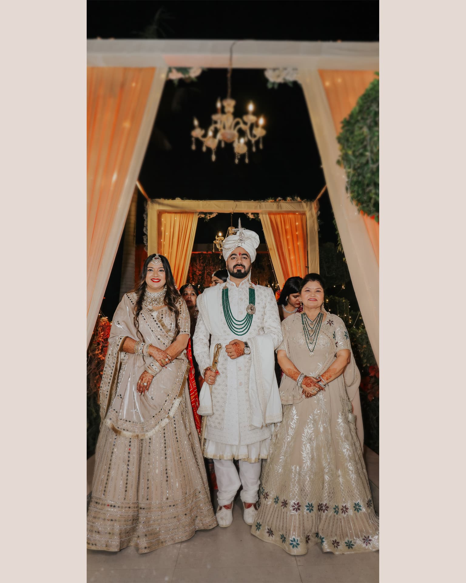 Anand escorted in by family in his ivory sherwani and turban