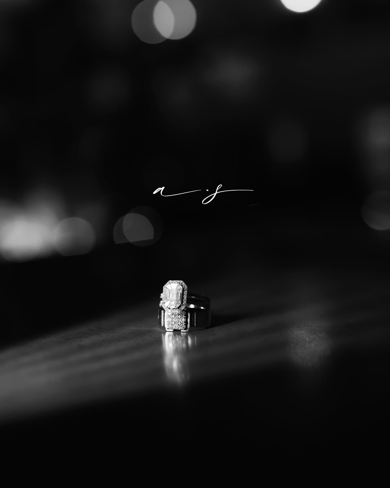 The engagement ring glowing against a dark bokeh backdrop