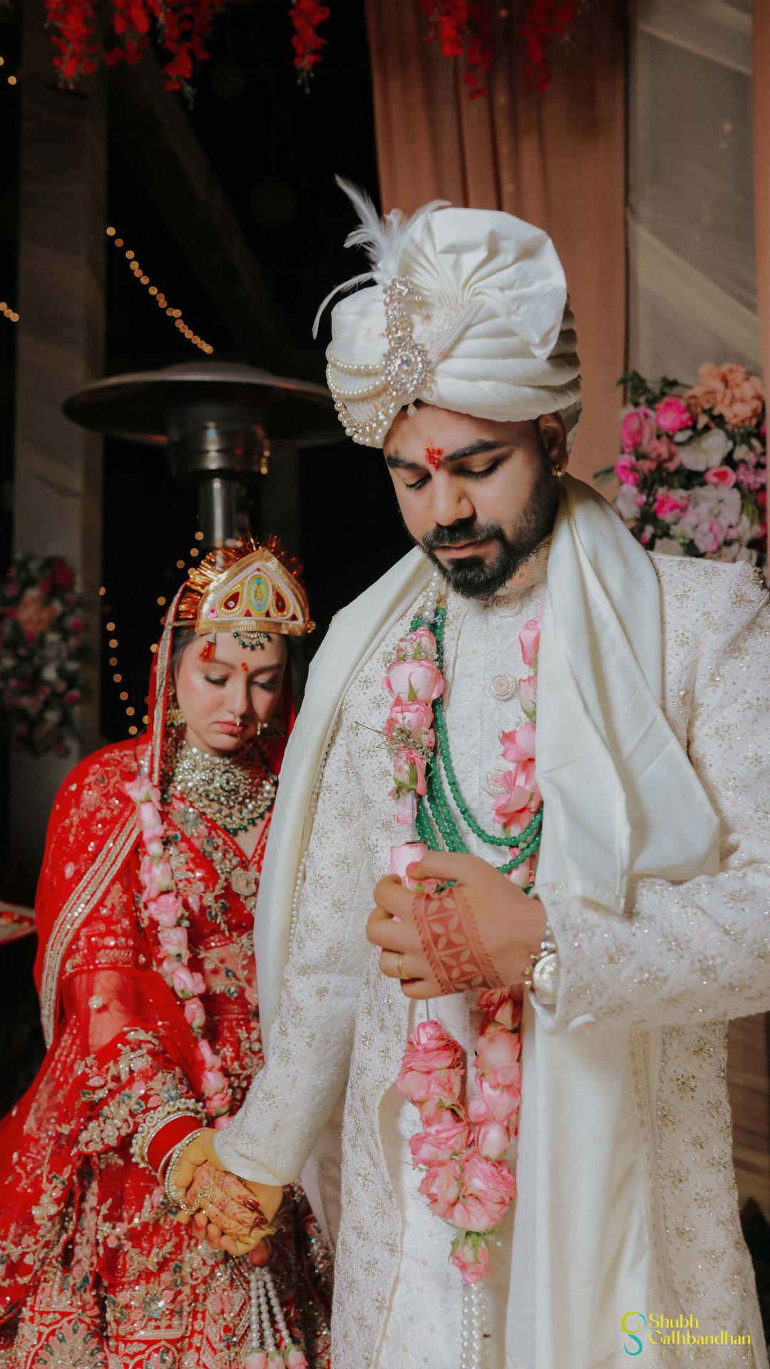 Anand in his ivory sherwani and rose garland with Soumya beside him