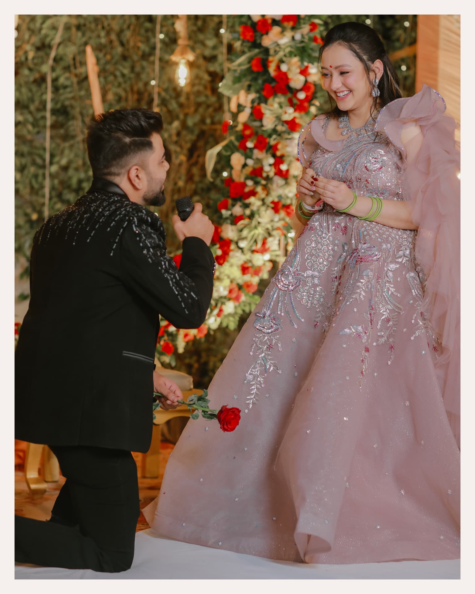 Anand proposing to Soumya with a red rose at their engagement
