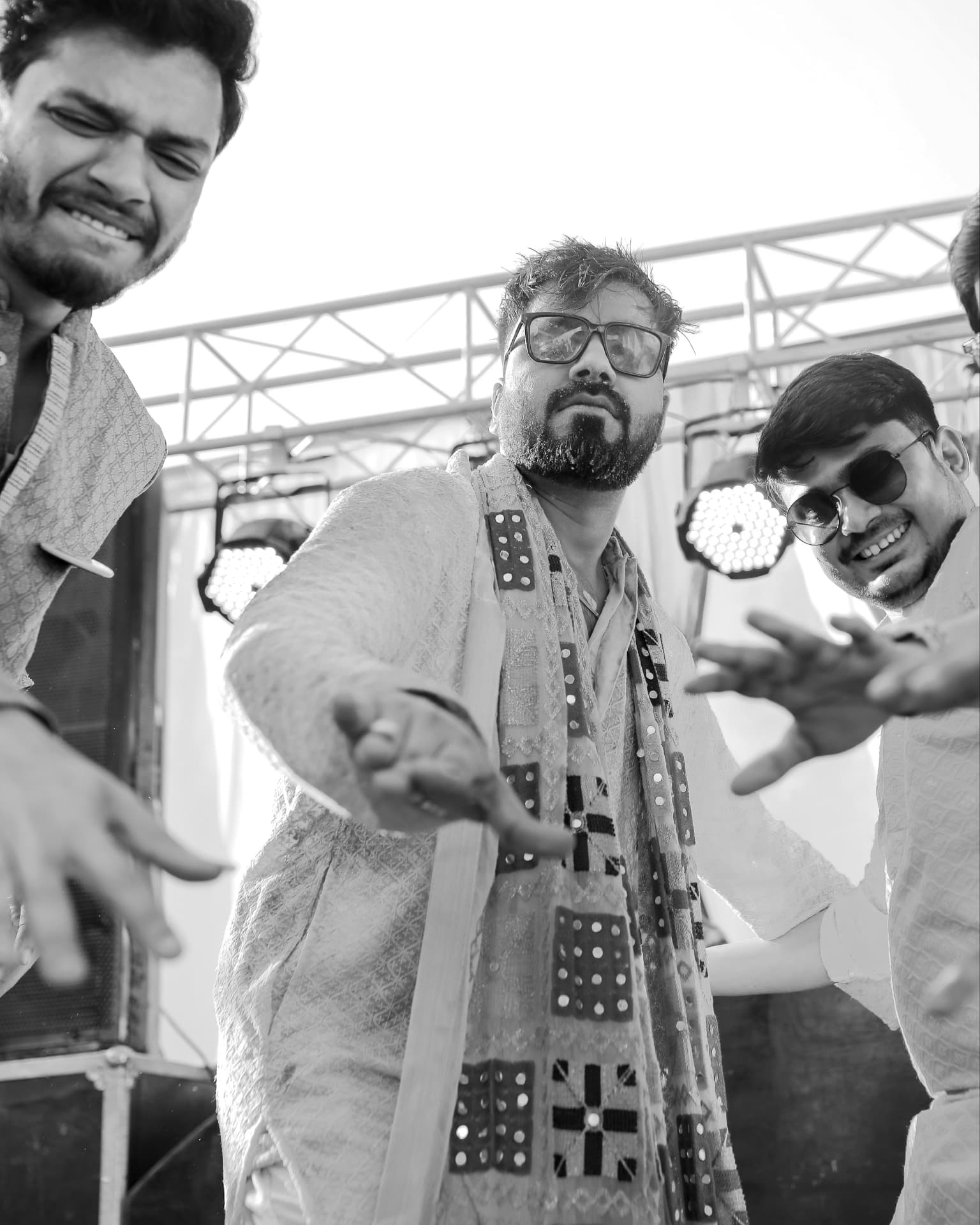 Anand dancing with his friends in black and white
