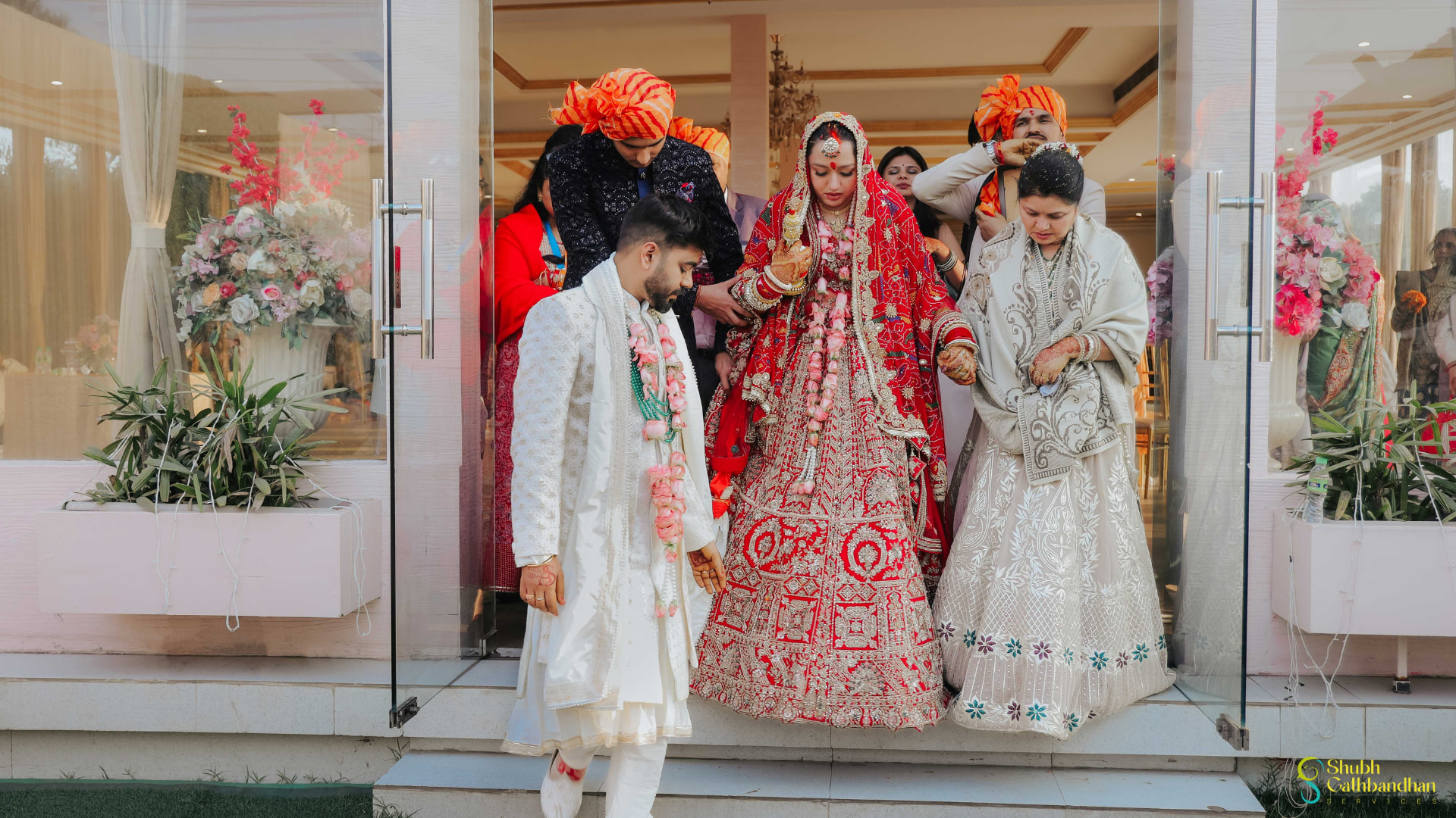 Soumya being escorted out of the venue by Anand and family after the wedding
