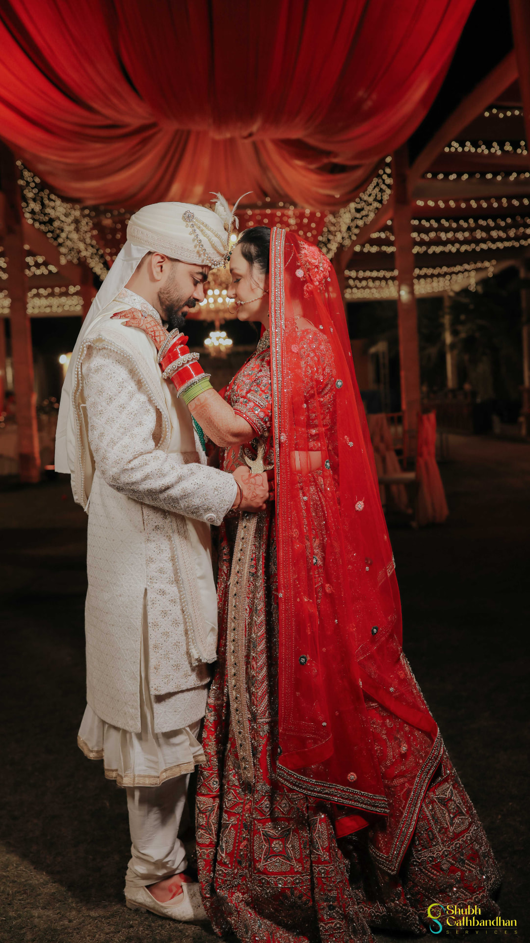 Wedding portrait of Anand and Soumya standing forehead to forehead