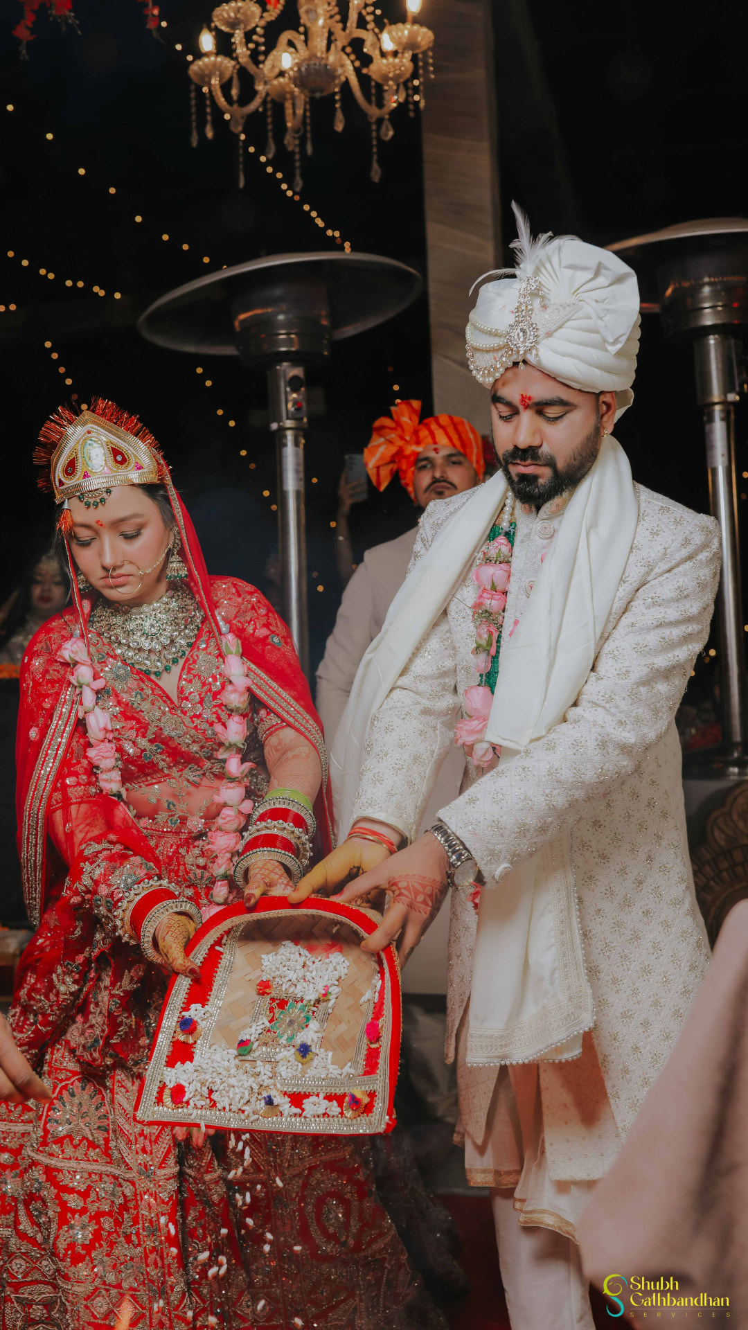 Anand and Soumya holding the ritual basket of puffed rice together