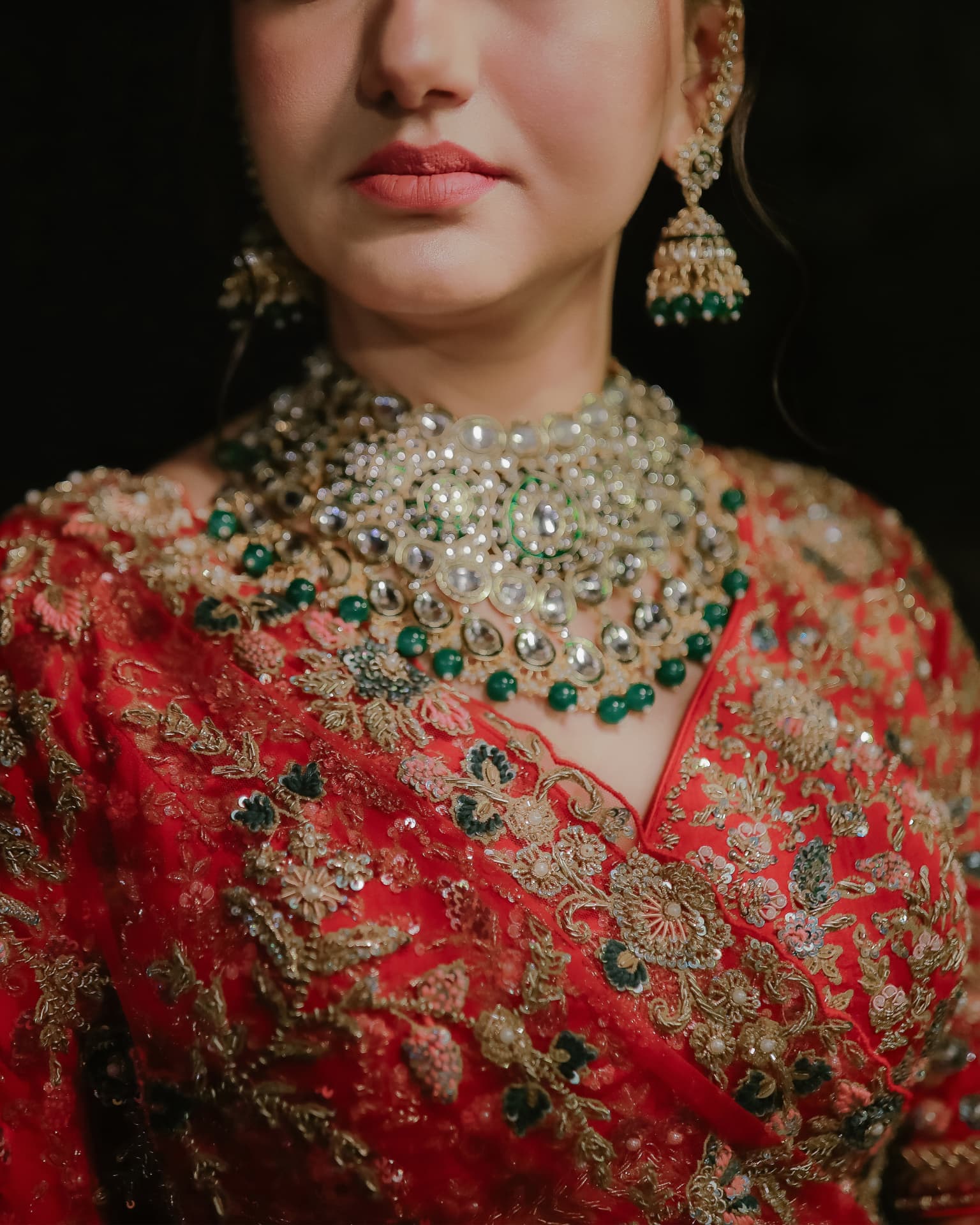 Close-up of Soumya's kundan bridal jewellery and red embroidery